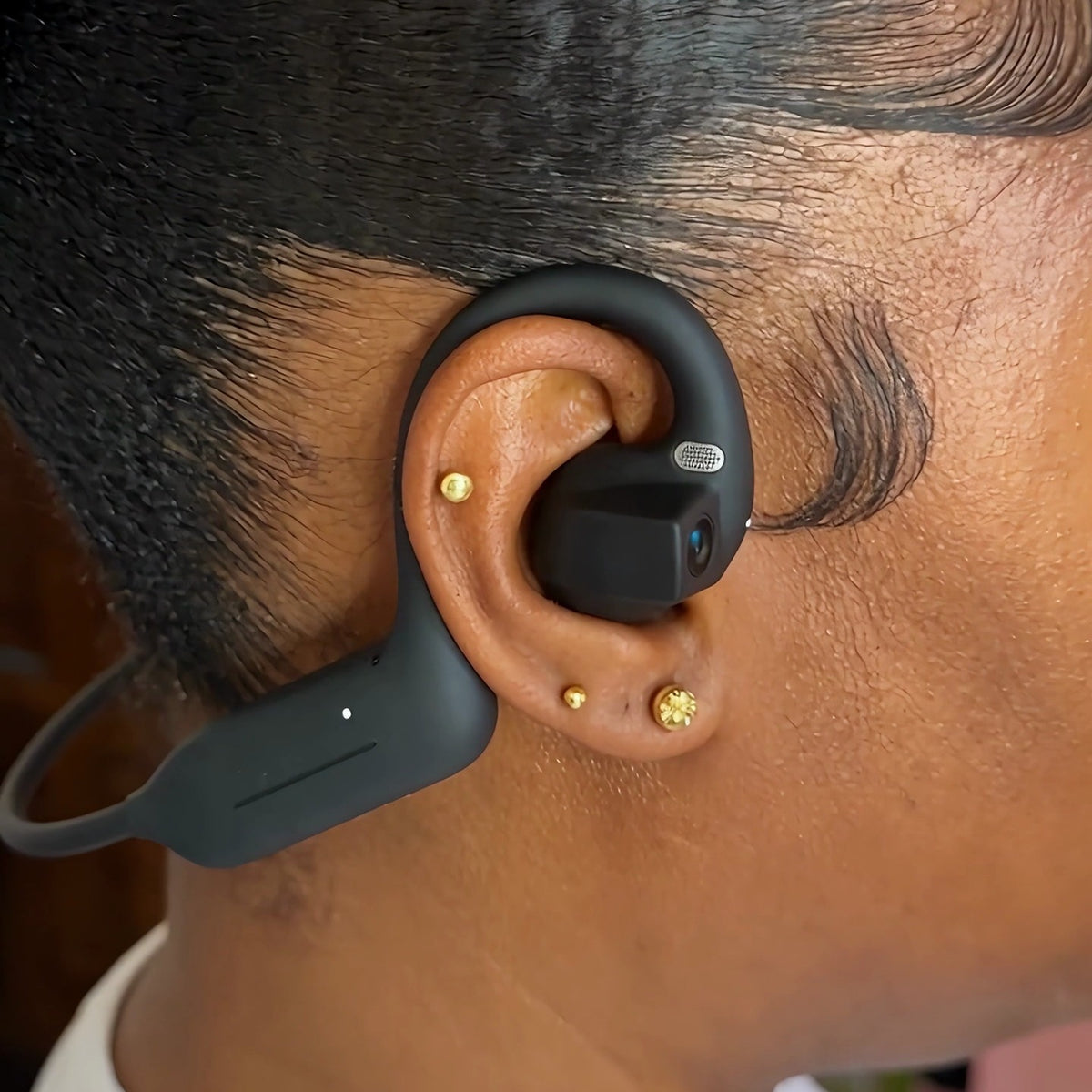 Woman wearing Echo Lens camera headphones on her ear